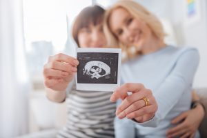 Lesbian Couple Holding Baby Scan Picture